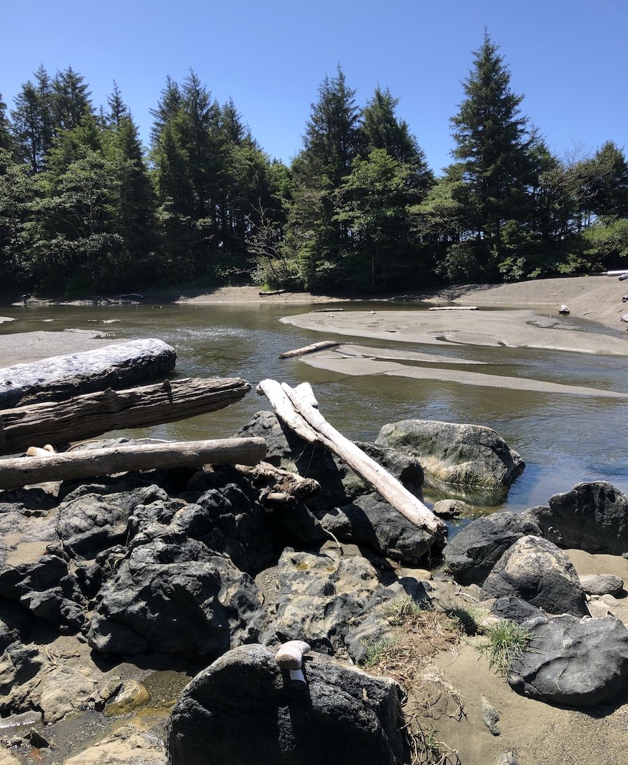 Hopping into muddy sand to ford this river on the West Coast Trail