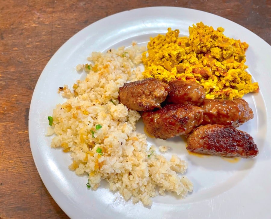 Keto-Friendly Low-Carb Filipino Fry-Up Breakfast with longanisa sausages, garlic fried cauliflower rice and a scramble with tomatoes and onions