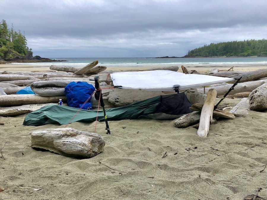 Bracing for a windy night with my bivy and tarp set-up to camp at Guise Bay, Cape Scott Trail, Cape Scott Provincial Park